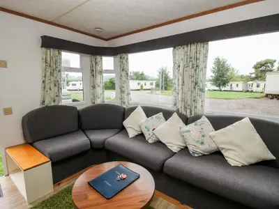 a living room with a couch and a table at 6 Old Orchard in Much Wenlock