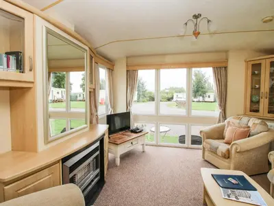 a caravan living room with a tv and a couch at 4 Old Orchard in Much Wenlock