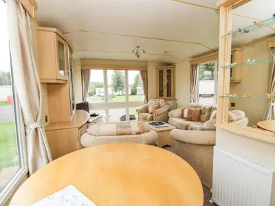a caravan living room with a table and chairs at 4 Old Orchard in Much Wenlock