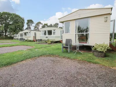 a house with a table and chairs in a yard at 2 Old Orchard in Much Wenlock