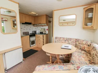 a living room with a couch and a table in a caravan at 9 Old Orchard in Much Wenlock