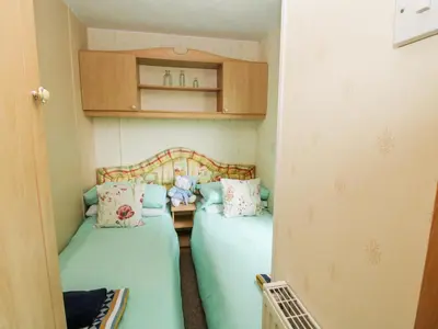 two twin beds in a small room with at 9 Old Orchard in Much Wenlock
