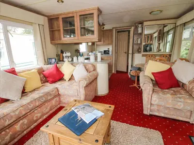 a living room with two couches and a table at 1 Old Orchard in Much Wenlock
