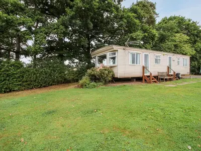 a caravan sitting in a field with a yard at 7 Old Orchard in Much Wenlock