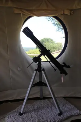 a telescope on a tripod in a tent at Heart of the Wye in Clifford