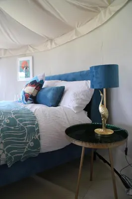 a bedroom with a bed and a table with a lamp at Heart of the Wye in Clifford