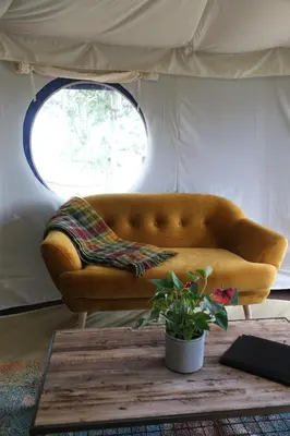 a couch sitting in a room with a window at Heart of the Wye in Clifford