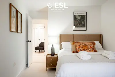 a bedroom with a bed with two towels on it at Contemporary Townhouse - Free Parking - Central Shrewsbury in Shrewsbury