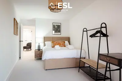 a white bedroom with a bed and a desk at Contemporary Townhouse - Free Parking - Central Shrewsbury in Shrewsbury