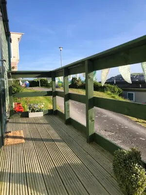 a wooden deck with a view of a street at Cosy holiday caravan minutes from the beach in Aberystwyth