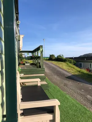 a row of benches on the side of a building at Cosy holiday caravan minutes from the beach in Aberystwyth