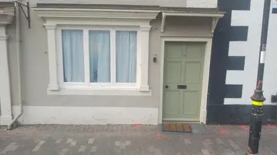 a house with a green door and a window at self contained flat in Llanfyllin Powys in Llanfyllin