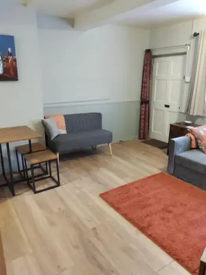 a living room with a couch and a table at self contained flat in Llanfyllin Powys in Llanfyllin
