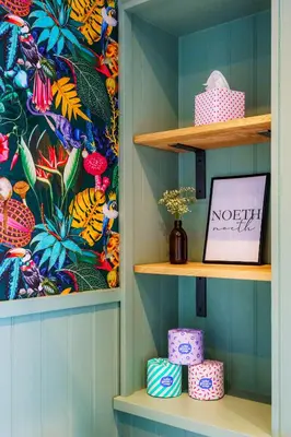 a room with a shelf with a tropical wallpaper at Loft Fach in Tregaron