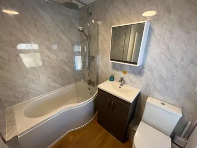 a bathroom with a tub and a sink and a toilet at Escapism Wales Gwalia in Llanrhystyd