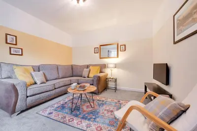 a living room with a couch and a table at 2 Bed in Barmouth oc-wag721 in Barmouth