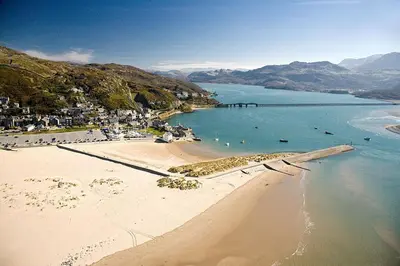 an aerial view of a beach with people in the water at 2 Bed in Barmouth oc-wag721 in Barmouth