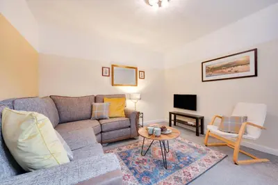 a living room with a couch and a tv at 2 Bed in Barmouth oc-wag721 in Barmouth