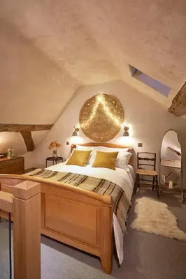 a bedroom with a large bed with a large orb above it at Kin Ludlow Rooms in Ludlow