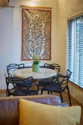 a table and chairs in a room with a painting on the wall at Kin Ludlow Rooms in Ludlow