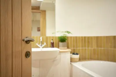 a bathroom with a bath tub and a sink at Kin Ludlow Rooms in Ludlow