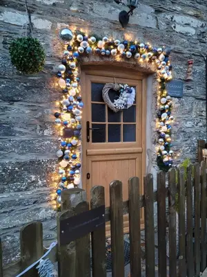 a door with christmas lights on a stone building at The Granary Corris on the edge of the Dyfi Forest in Corris