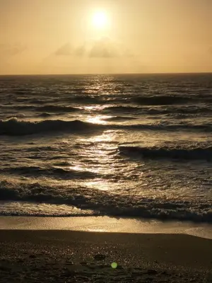 a sunset on the beach with the ocean at The Granary Corris on the edge of the Dyfi Forest in Corris