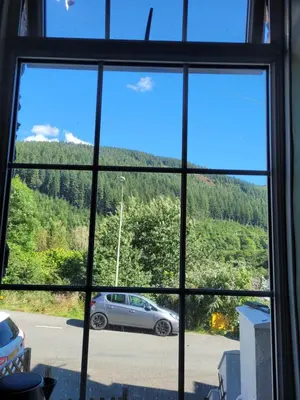a window view of a car parked in a parking lot at Ty Golchi - Cosy traditional cottage in Corris in Corris