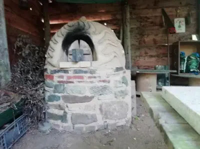 a brick oven sitting inside of a building at Sapphire forest garden shepherd’s hut in Church Stretton