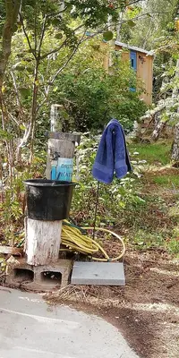 a fire hydrant with a blue hat on top of it at Sapphire forest garden shepherd’s hut in Church Stretton