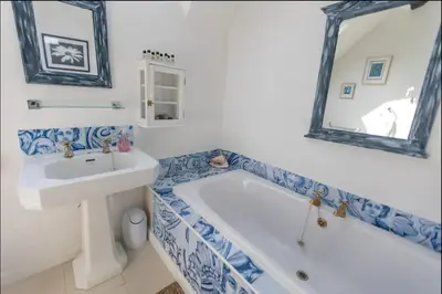 a bathroom with a sink and a tub and a mirror at Magical period house in the heart of Ludlow - Pass the Keys in Ludlow