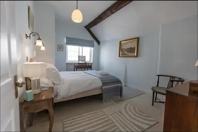 a bedroom with a bed and a table with a lamp at Magical period house in the heart of Ludlow - Pass the Keys in Ludlow