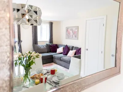 a mirror reflecting a living room with a couch at Stylish modern two bedroom home in Shrewsbury - Pass the Keys in Shrewsbury