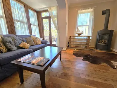 a living room with a couch and a wood stove at Luxury 5 bedroom Riverside home in town centre - Pass the Keys in Shrewsbury