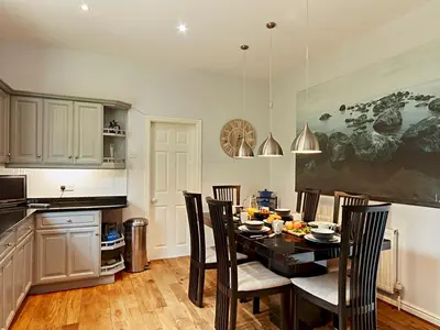 a kitchen with a dining room table and chairs at Luxury 5 bedroom Riverside home in town centre - Pass the Keys in Shrewsbury