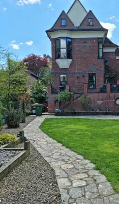 a brick house with a walkway in front of a yard at Luxury 5 bedroom Riverside home in town centre - Pass the Keys in Shrewsbury