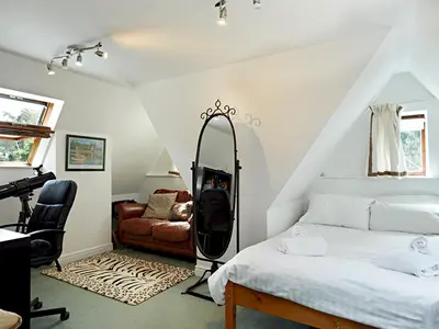 a bedroom with a bed with a mirror and a desk at Luxury 5 bedroom Riverside home in town centre - Pass the Keys in Shrewsbury