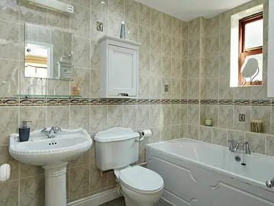 a bathroom with a toilet and a sink and a tub at Luxury 5 bedroom Riverside home in town centre - Pass the Keys in Shrewsbury