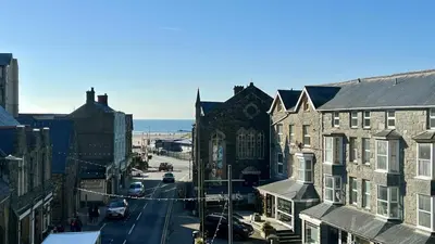 a view of a street in a city with buildings at Luxury 4 Bedroom Seaside Apartment - Glan Y Werydd House in Barmouth