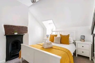 a bedroom with a bed and a fireplace at The Cwtch in Brecon