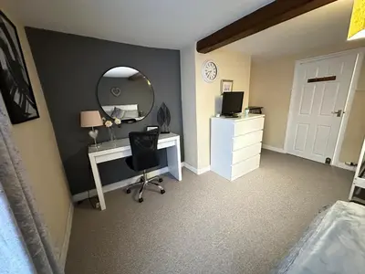 a bedroom with a desk and a mirror and a computer at Llanidloes Townhouse-pet-friendly-sleeps 7-Mid Wales in Llanidloes