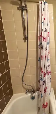 a bathroom with a shower curtain and a tub at Llanidloes Townhouse-pet-friendly-sleeps 7-Mid Wales in Llanidloes