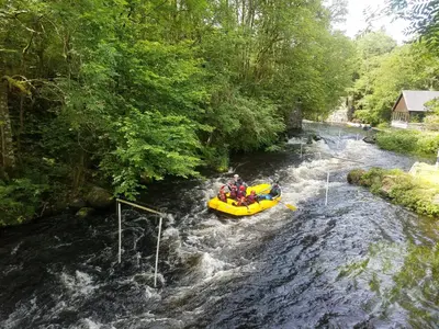 a person in a raft in a river at Rhydydefaid Cwt Clyd - Cosy Hut in Bala