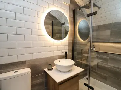 a bathroom with a toilet and a sink and a shower at Tan Y Wawr - Derwen in Welshpool
