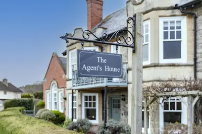 a sign that reads the agents house in front of a house at The Agents House, Bed & Breakfast in Hay-on-Wye