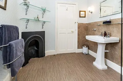 a bathroom with a fireplace and a sink at The Agents House, Bed & Breakfast in Hay-on-Wye