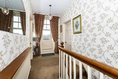 a staircase in a home with wallpaper at The Agents House, Bed & Breakfast in Hay-on-Wye