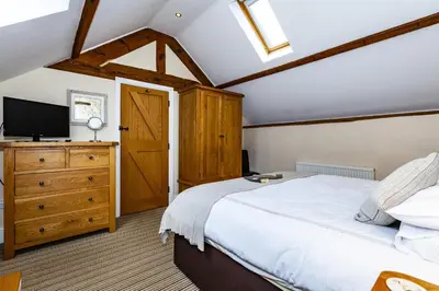 a bedroom with a large bed and a tv at The Agents House, Bed & Breakfast in Hay-on-Wye