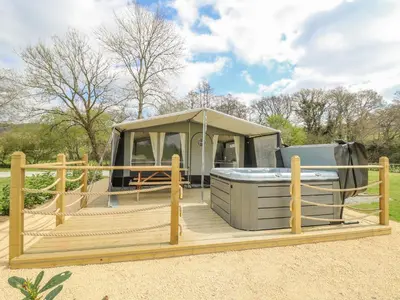 a gazebo with a hot tub on a wooden deck at The Salmon in Rhayader