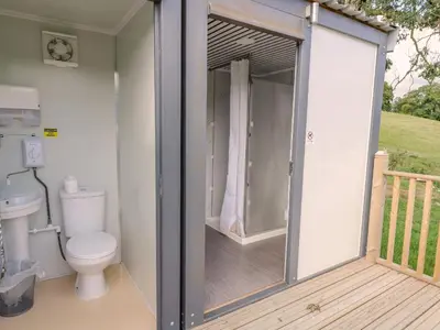 a bathroom with a toilet on a deck at The Salmon in Rhayader